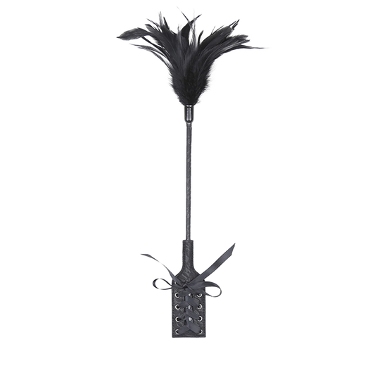 Black feather whip with an attached paddle with vintage design on a white background.